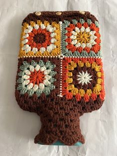 a crocheted pot holder is sitting on a table