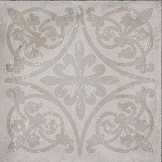 a white and gray rug with an ornate design on the bottom, in grey tones