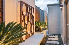 an outdoor area with stone steps, plants and lights on the side of the building