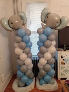 two elephant balloons are on top of each other