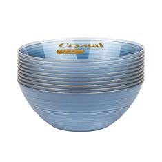 blue glass bowls stacked on top of each other with the word crystal written in gold