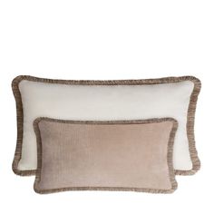 two pillows on top of each other with white and brown trimmings, one in the