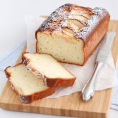 a loaf of pound cake sitting on top of a wooden cutting board