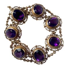 Each link in this bracelet is loaded with detail and holds seven gorgeous amethyst stones. The style of the bracelet has a very Art Deco feel and is wonderfully stylish. Bracelet Length: 6.5inches Width: 19mm Weight: 29.3g Luxury Art Deco Amethyst Ring, Luxury Victorian Amethyst Jewelry, Amethyst Gold Bracelet, Antique Purple Bracelets For Formal Occasions, Classic Purple Bracelet Jewelry, Antique Amethyst Jewelry, Bracelet Art, Antique Jewellery Designs, Jewellery Vintage