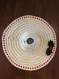 a crocheted christmas ornament on a wooden floor