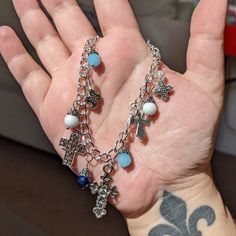 This sweet silver charm bracelet features beautiful ornate cross charms and bright blue glass gems for a pop of color. The silver curb chain feels solid but not too heavy and there are just enough charms to gently jingle when you move your wrist. This bracelet features a lobster claw clasp! This bracelet is 8.5 inches long including the clasp. We can adjust this bracelet to be about 8 inches long if you'd like - just leave a note in your order! Ornate Cross, Jewelry Accessories Ideas, Blue Cross, Glass Gems, Accessories Ideas, Silver Charm Bracelet, Cross Charms, Curb Chain, Charm Bracelets