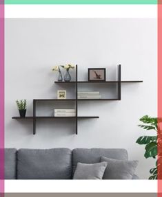 a living room filled with furniture and decor on top of a white wall next to a potted plant