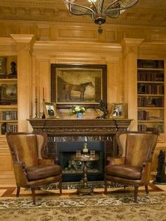 a living room filled with furniture and a fire place in front of a painting on the wall