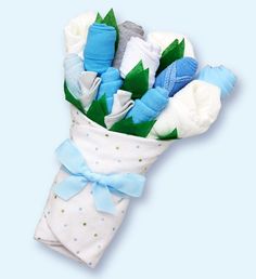 a bouquet of baby swaddles with blue and white flowers in them on a light blue background