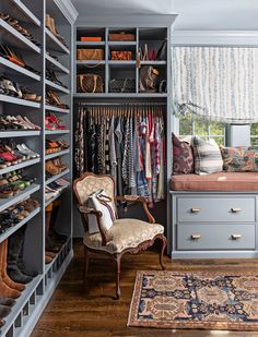 a walk in closet filled with lots of shoes and other items, including a chair