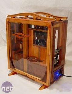 an old fashioned wooden computer case with glass doors on the front and sides, sitting on a white background