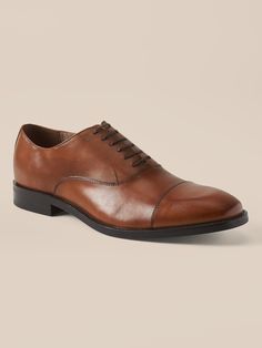 A clean and classic dress shoe with subtle cap-toe design, made in luxurious Italian leather.  Style with no-show socks and a smirk for an irreverent twist that's all confidence.  Flexible, leather or suede upper.  Designed with lightweight, durable Leather Cap Toe Oxfords For Fall, Business Casual Cap Toe Oxfords With Rubber Sole, Fall Oxfords With Rubber Sole Cap Toe, Fall Cap Toe Oxfords With Rubber Sole, Fitted Cap Toe Leather Shoes For Fall, Fall Cap Toe Leather Shoes, Business Casual Oxfords With Almond Toe And Leather Footbed, Masculine Cap Toe Oxfords With Leather Sole, Classic Cap Toe Dress Shoes With Rubber Sole