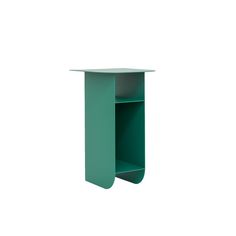 a small green shelf sitting on top of a white wall