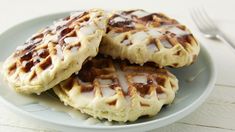 three waffles with icing on a plate