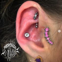 an ear with three different piercings on it