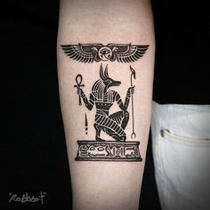 a black and white photo of an egyptian tattoo