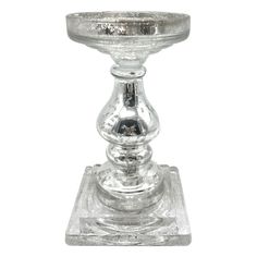 an old fashioned glass candle holder on a white background