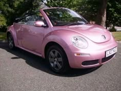 a pink car is parked on the street