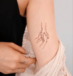 a woman with a small tattoo on her arm