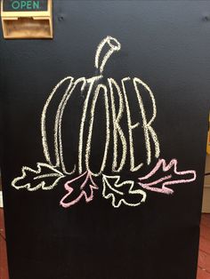 a chalkboard with writing on it that says october and an apple is drawn on the side