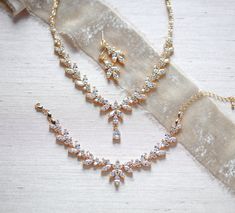 "The classic design of this radiant rose gold bridal necklace set is perfect for brides who truly want to shine! - Necklace measures 16\" - Earrings measure 1\" - Bracelet measures 6\" and extends to 8 inches - Handcrafted with high quality cubic zirconia - Available in rose gold, yellow gold and rhodium (silver) finish Browse My Entire Shop For More Jewelry & Accessories: https://www.etsy.com/shop/TheExquisiteBride Browse My Shop For Earrings: https://www.etsy.com/shop/TheExquisiteBride?sec Elegant Rose Gold Jewelry Sets For Formal Occasions, Formal Rose Gold Jewelry Sets With Elegant Design, Formal Rose Gold Elegant Jewelry Sets, Formal Elegant Rose Gold Jewelry Sets, Elegant Rose Gold Hand Set Bridal Necklace, Elegant Rose Gold Jewelry For Mother Of The Bride, Gold Elegant Jewelry Sets For Mother Of The Bride, Elegant Gold Jewelry Sets For Mother Of The Bride, Hand Set Rose Gold Jewelry Sets For Wedding