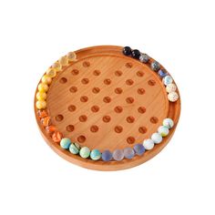 a wooden tray with several beads on the bottom and one bead in the middle