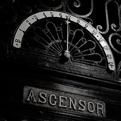 an old fashioned clock with the word ascendsor on it's face and hands