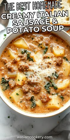 the best homemade creamy italian sausage and potato soup in a white bowl with bread on the side