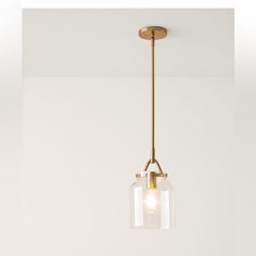 a light fixture hanging from the ceiling in a room with white walls and flooring