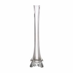 a tall glass vase sitting on top of a table