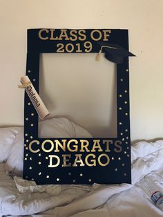 a graduation photo frame that says congrats dego with a cap and diploma