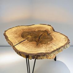 a piece of wood that has been cut in half and is sitting on some metal legs