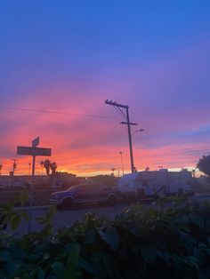 the sun is setting over an rv park