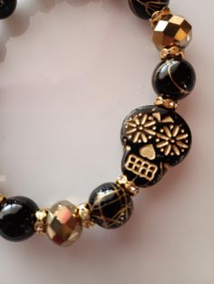 Lots of sparkle! Black and gold Halloween Skull. Adjustable Gold Jewelry For Halloween, Gold Skull Jewelry For Party, Adjustable Gold Skull Bracelets, Gold Adjustable Skull Bracelets, Halloween Skull Print Bracelet Gift, Adjustable Gold Bracelets For Halloween, Skull Shaped Jewelry For Day Of The Dead Party, Skull Jewelry For Day Of The Dead Party, Black Jewelry For Day Of The Dead Gift