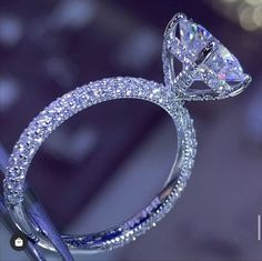 a diamond ring is shown in front of a blurry background