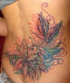 a woman's stomach with flowers and swirls on it