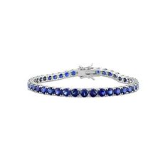 This 14.49 carat (ctw) lab-Created Blue Sapphire Classic Tennis Bracelet in Sterling Silver is the perfect combination of elegance and sophistication. The tennis bracelet design features 37 triangle-cut lab-created blue sapphires in a classic prong setting, totaling 14-1/2 carats. The sterling silver bracelet is polished to a high shine, giving it a luxurious look and feel. 14.49 Carat (ctw) Lab-Created Blue Sapphire Bracelet in Sterling Silver (7.25 Inches) Size: one size.  Gender: female.  Age Luxury Blue Tennis Bracelet, Luxury Blue Diamond Bracelet With Brilliant Cut, Blue Diamond Bracelet With Brilliant Cut Luxury Style, Luxury Blue Gemstone Tennis Bracelet, Luxury Blue Diamond Bracelet For Formal Events, Luxury Blue Diamond Bracelet For Formal Occasions, Luxury Blue Cubic Zirconia Bracelets, Blue Sapphire Oval Tennis Bracelet, Blue Sapphire Tennis Bracelet With Gemstone