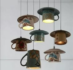 several coffee cups hanging from the ceiling