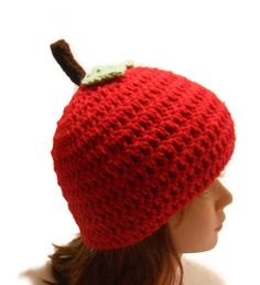 a crocheted red hat with an apple on top