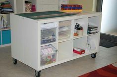 a kitchen island with several storage bins on wheels