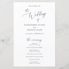 the wedding program card is shown on a marble surface with an elegant calligraphy font