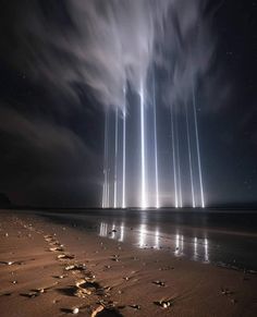 a long line of lightening is seen in the sky above a beach at night