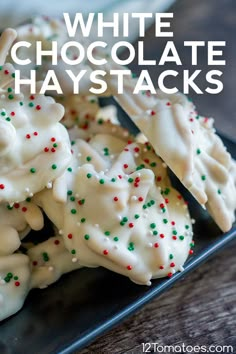 there are many cookies with white frosting and sprinkles on them,