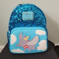 Loungefly Disney Dumbo Mini Backpack Blue Sequin Vegan Leather Bag Nwt New With Tags Characters: Dumbo & Timothy On The Back Is A Picture Of Dumbo And Partially Embroidered "Don't Just Fly, Soar!" Front Zipper Pocket 2 Side Pockets Adjustable Straps Hang Loop 11x4x5 From A Smoke Free Home Blue Backpack With Zipper For Disney Trips, Blue Disney Backpack With Adjustable Strap, Blue Disney Backpack With Zipper Closure, Blue Disney Backpack For Daily Use, Blue Disney Backpack For Travel, Blue Disney Travel Backpack, Blue Backpack For Disney Trips With Adjustable Strap, Blue Backpack With Adjustable Strap For Disney Trips, Blue Disney Bag With Zipper Closure