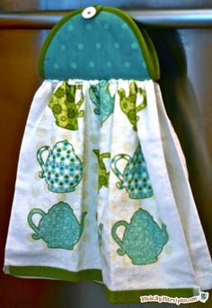 a green and white towel hanging on a rack