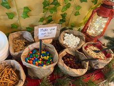 a table topped with lots of bags filled with candy and candies next to a red lantern