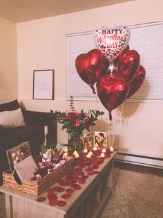 valentine's day decorations on a table with candles and balloons