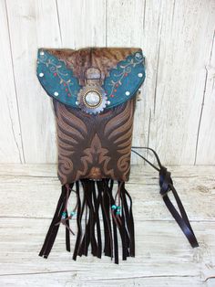 Crafted with a blend of rugged charm and western allure, these one-of-a-kind Leather Crossbody Hipster Purses are the epitome of cowgirl chic. Handcrafted from authentic cowboy boots, each purse exudes a sense of unique style that is perfect for those who embrace country fashion. The fringe detailing adds a touch of flair reminiscent of rodeo culture, making it a must-have accessory for any modern cowgirl. Whether you're hitting the town or attending a western-themed event, these purses effortlessly blend into your wardrobe, elevating your outfit with a dash of western chic. Embrace your inner cowgirl and make a bold statement with these stylish and versatile Crossbody Purses that are bound to turn heads wherever you go.  Cowboy Boot Crossbody Fringe Hipster Bag Handcrafted from Recycled C Western Bags With Concho Detail, Western Style Bags With Concho, Western Style Brown Bag With Concho, Hand Tooled Brown Bags For Rodeo, Hand Tooled Brown Bag For Rodeo, Brown Hand Tooled Bag For Rodeo, Western Style Crossbody Bags For Western-themed Events, Western Brown Bags For Rodeo, Western Style Brown Bags For Rodeo