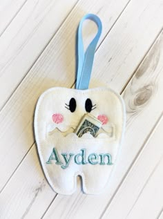 a tooth shaped ornament hanging on a wall