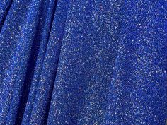 This high-quality glitter knit fabric offers excellent 4-way stretch, providing both comfort and flexibility for your garments. Its lurex composition adds a beautiful sheen, making it ideal for evening gowns, cocktail dresses, and other special occasion wear. Whether you're designing a show-stopping dress or adding accents to your creations, this fabric will elevate your designs to a whole new level of elegance and sophistication. Multiple yardage will come in one piece. We guarantee premium qua Fitted Blue Sequin Fabric With Glitter, Blue Fitted Sequin Fabric, Lurex Knit, Glitter Fabric, Stylish Fashion, Fabric Covered, Costume Design, Dance Wear, Occasion Wear